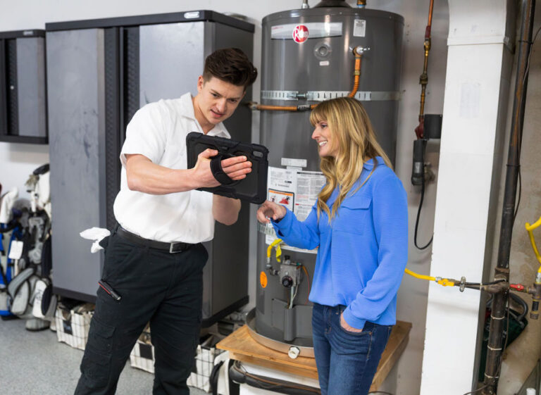 Man showing information to woman about a water heater in seattle