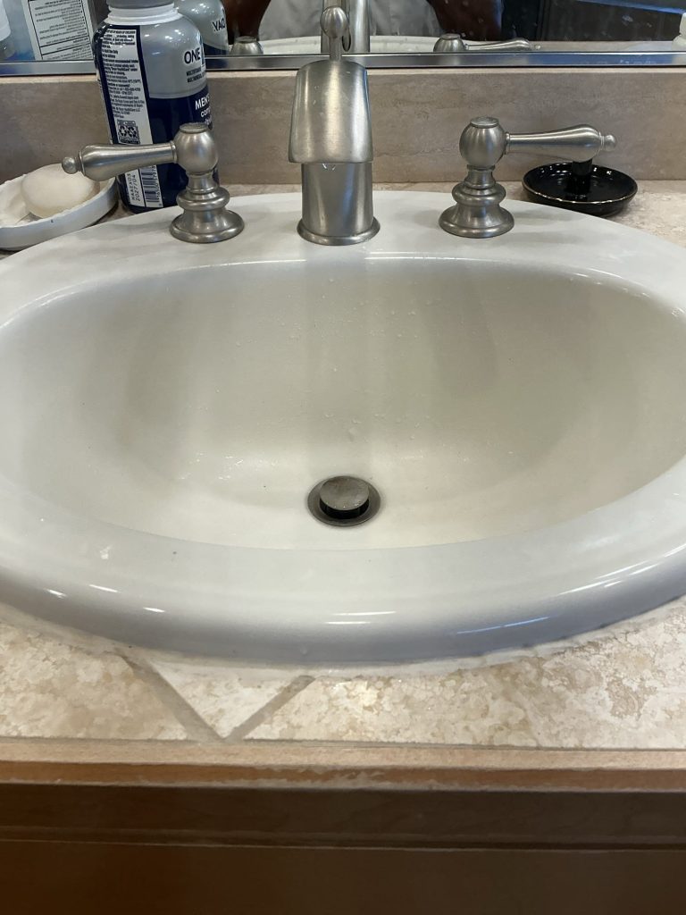 Clean master bathroom sink draining freely after the P-trap was reinstalled and the line cleared in Kirkland, WA