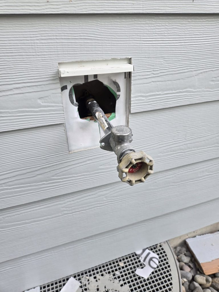 New frost-free hose bibb set through a siding mounting block on a Burien, WA home before the trim was finished