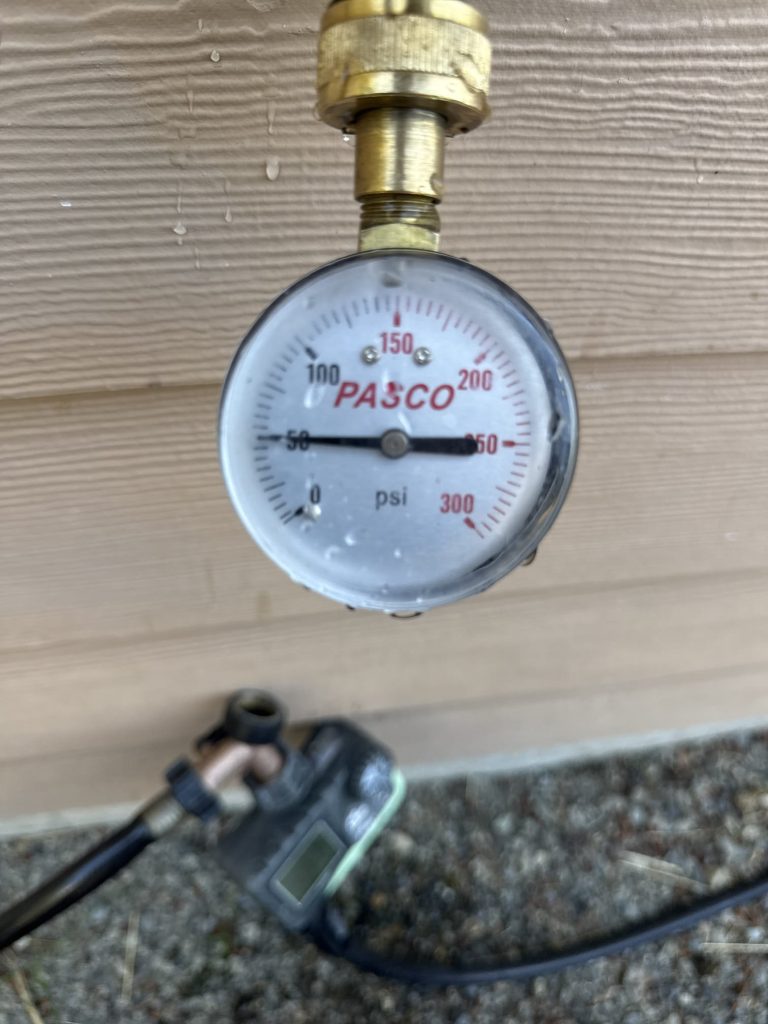 Pasco pressure gauge on an exterior hose bib used to check the home's water pressure during the visit